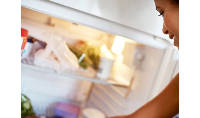 Girl opening fridge