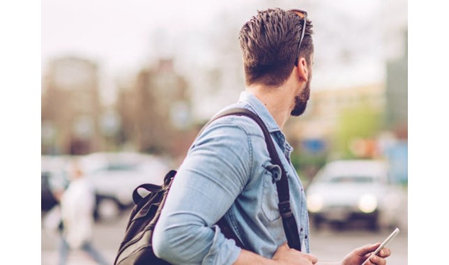 Man looking at the cars on the street