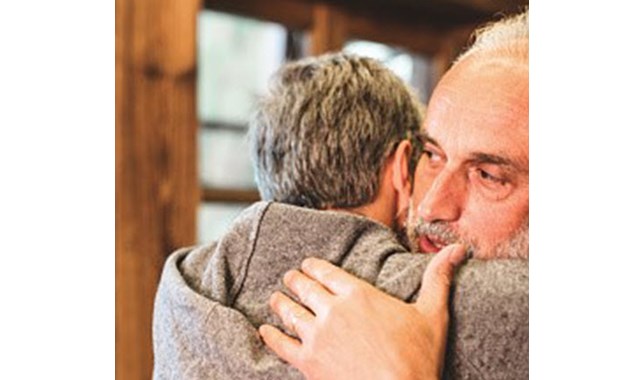 Son hugging father